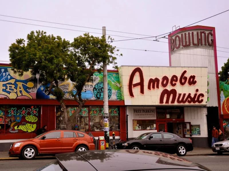 Exterior of Amoeba Music San Francisco with retro marquee and colorful murals along Haight Street.