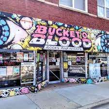 Colorful storefront of Bucket O' Blood Books and Records in Chicago, featuring bold graffiti-style signage and posters in the window.