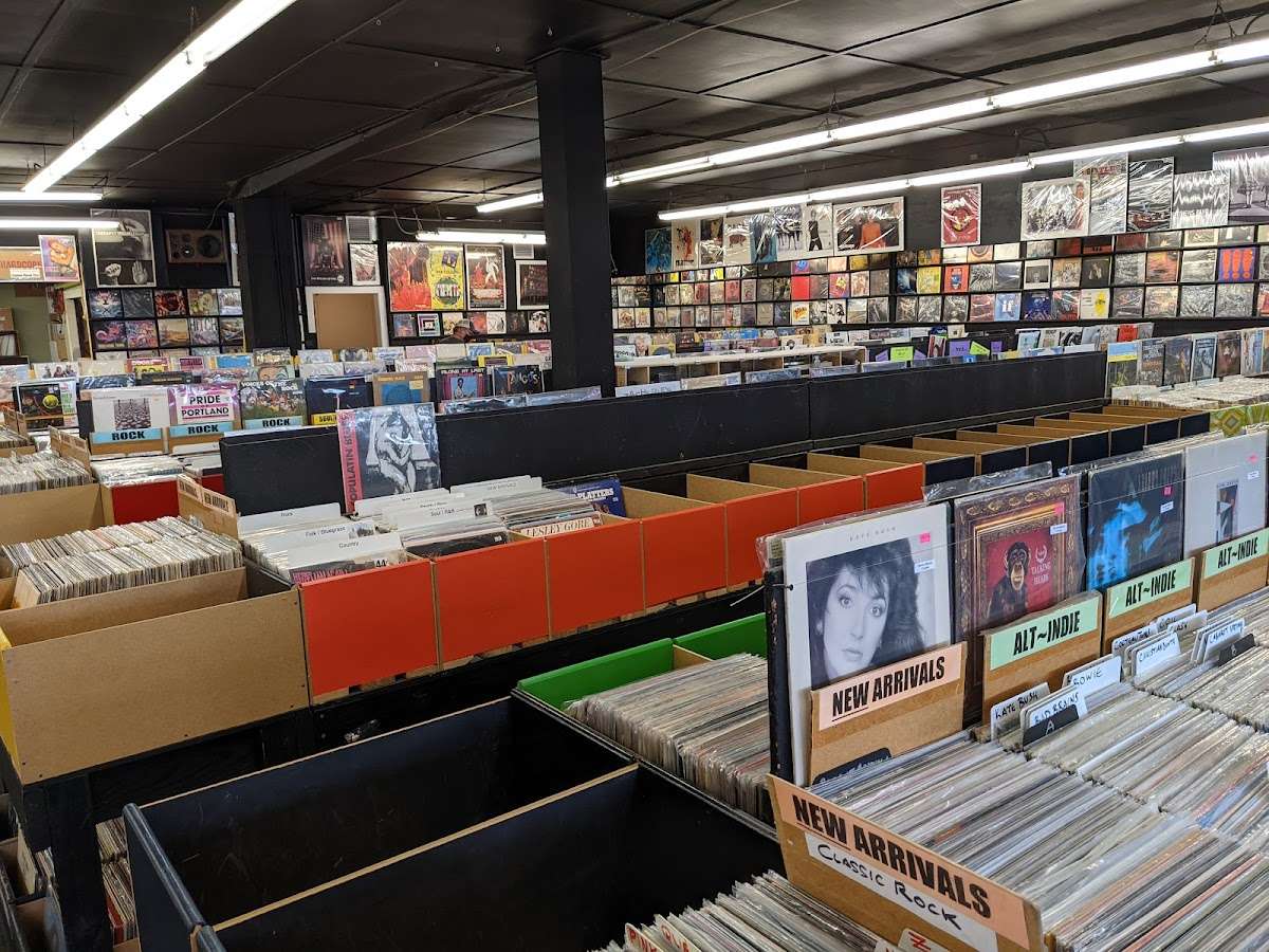 Interior view of Crossroads Music in Portland, Oregon, showing rows of record bins filled with vinyl across every genre, from alt-indie to classic rock.