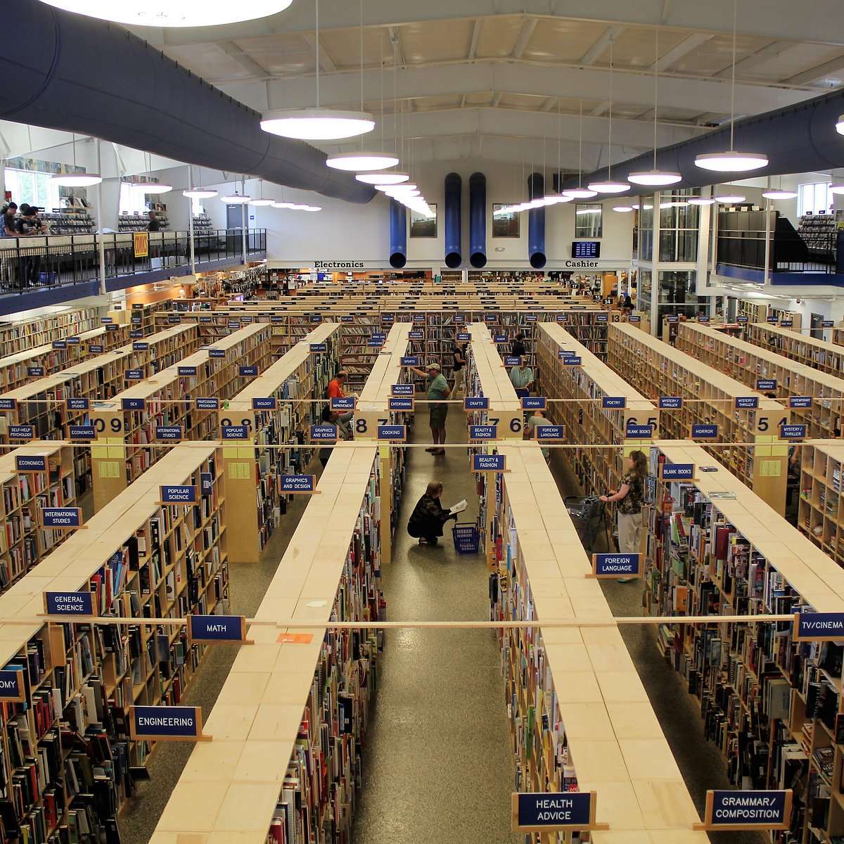 Interior of McKay's bookstore and media store with massive rows of shelves filled with books, music, and records organized by category.