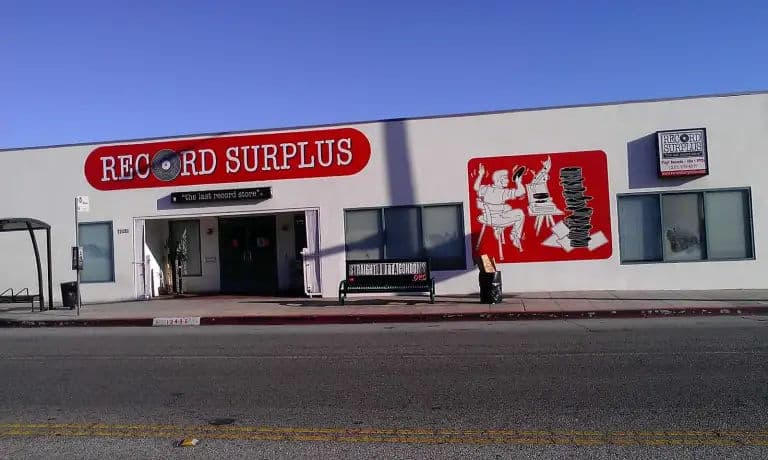 Exterior of Record Surplus in Los Angeles, featuring its signature red-and-white mural and the tagline The Last Record Store.