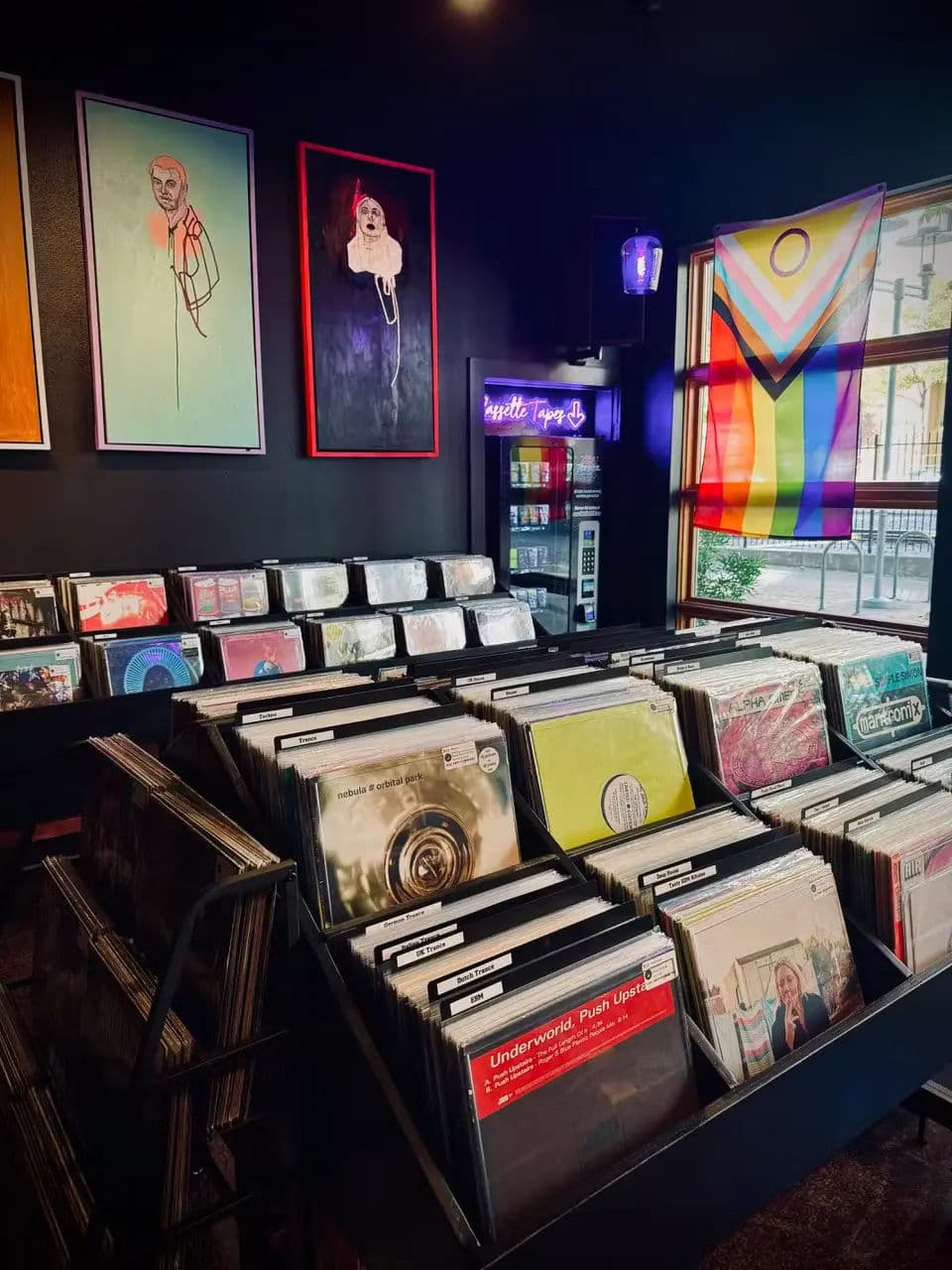 Interior of Sunshine Vinyl record shop with rows of neatly arranged bins full of records.