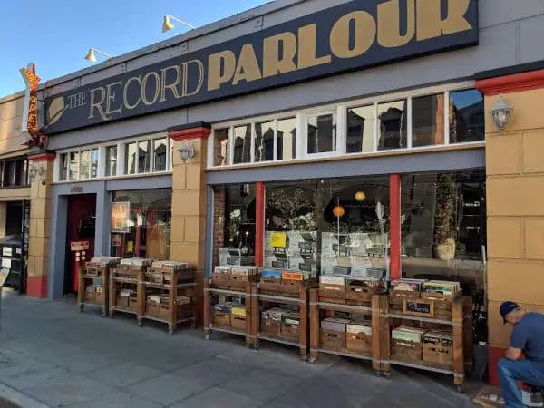 Exterior of The Record Parlour in Hollywood, featuring a black-and-gold storefront with wooden crates on the sidewalk.