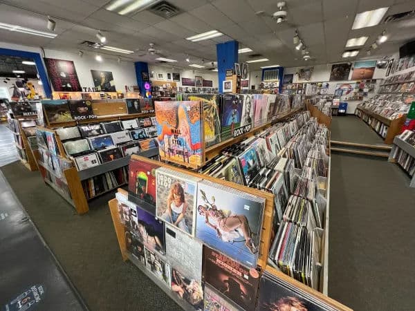Interior of Waterloo Records, a large record store with wide aisles and rows of wooden bins filled with vinyl records.