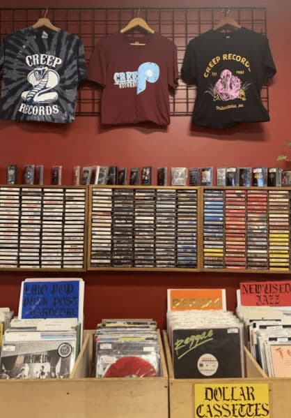 Exterior of Creep Records in Fishtown, showing the storefront with punk-inspired signage and posters visible through the windows.